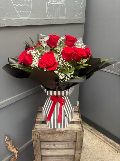 Pinstripe romance - 12 gorgeous long stemmed large headed red roses, presented in a striking pinstripe box, tied with a luxury red velvet ribbon